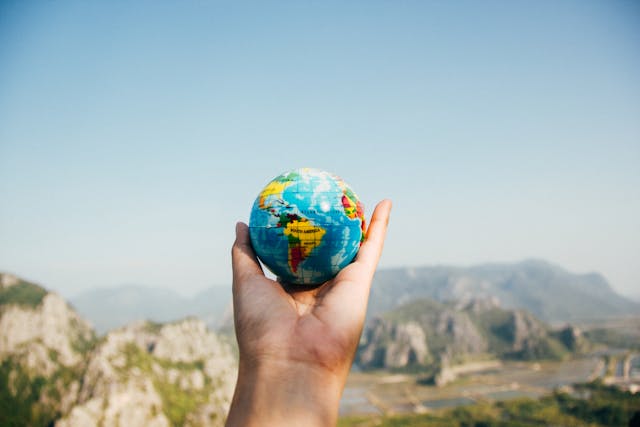A hand holding a globe illustrating our global reach